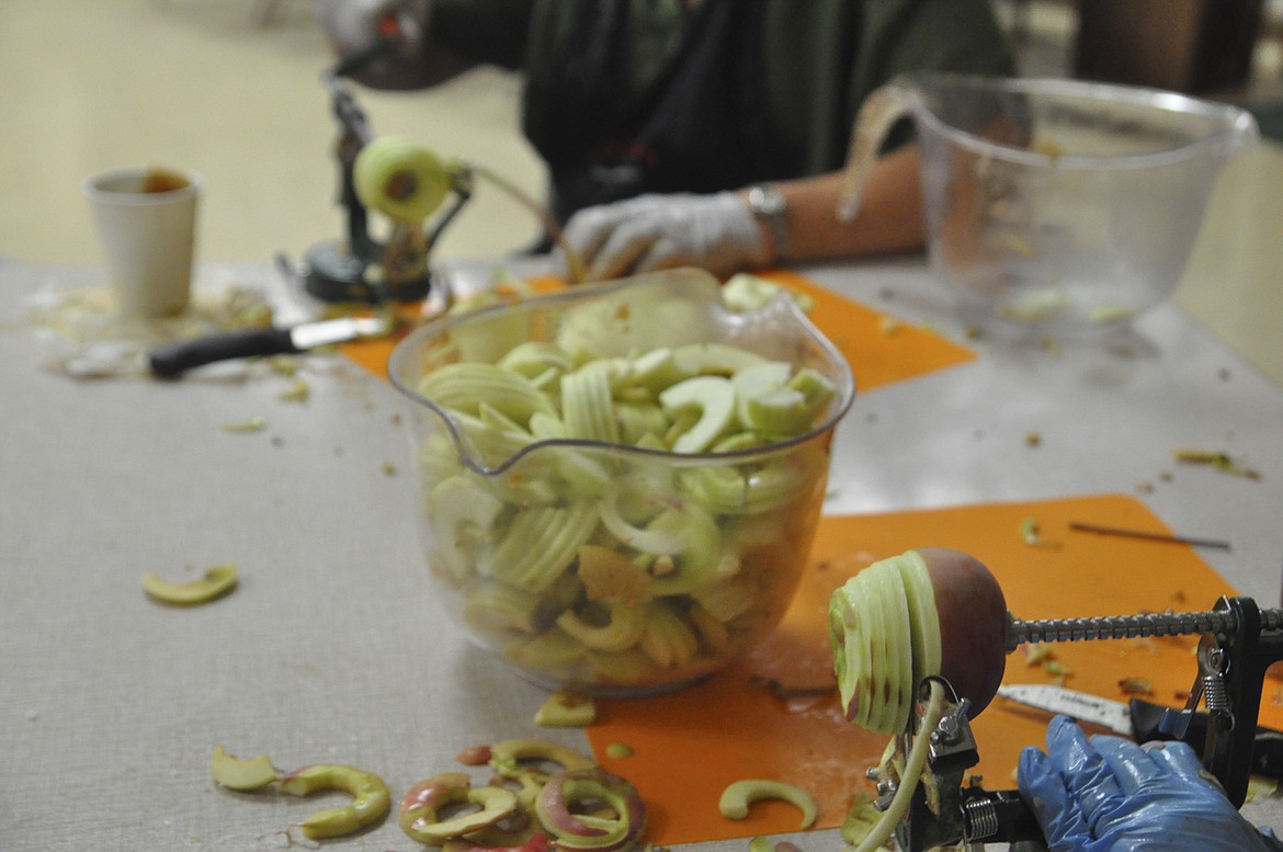 Volunteers sliced, peeled and mixed apples for pies that will be sold at Immaculate Conception Catholic Church Saturday for the Fall Apple Fest. (Ashley Fox/Lake County Leader)