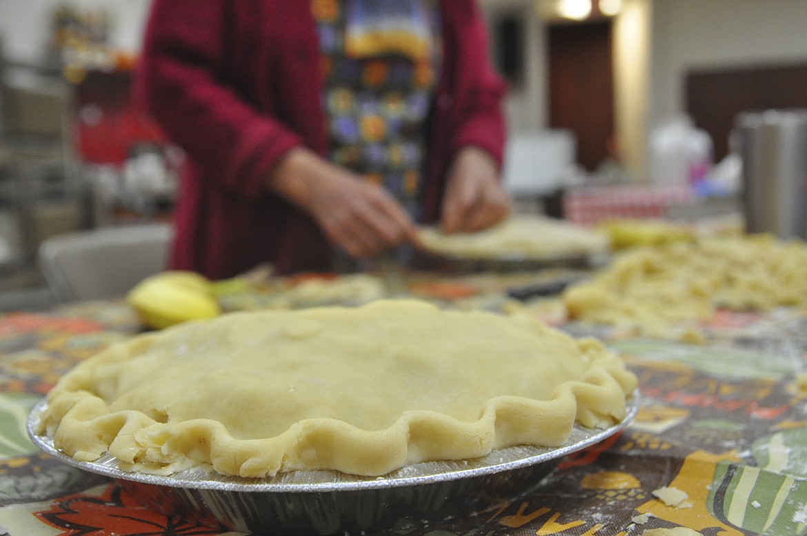 A team of 20 volunteers assembled 350 apple pies that were placed in freezers at Immaculate Conception Catholic Church in Polson Saturday. The pies will be sold at this weekend&#146;s Fall Apple Fest in the church basement. (Ashley Fox/Lake County Leader)