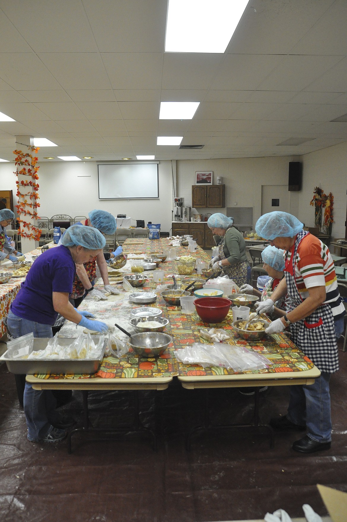 Twenty volunteers worked in stations at Immaculate Conception Catholic Church in Polson Saturday, assembling hundreds of apple pies for the parish&#146;s annual Apple Festival this weekend. (Ashley Fox/Lake County Leader)