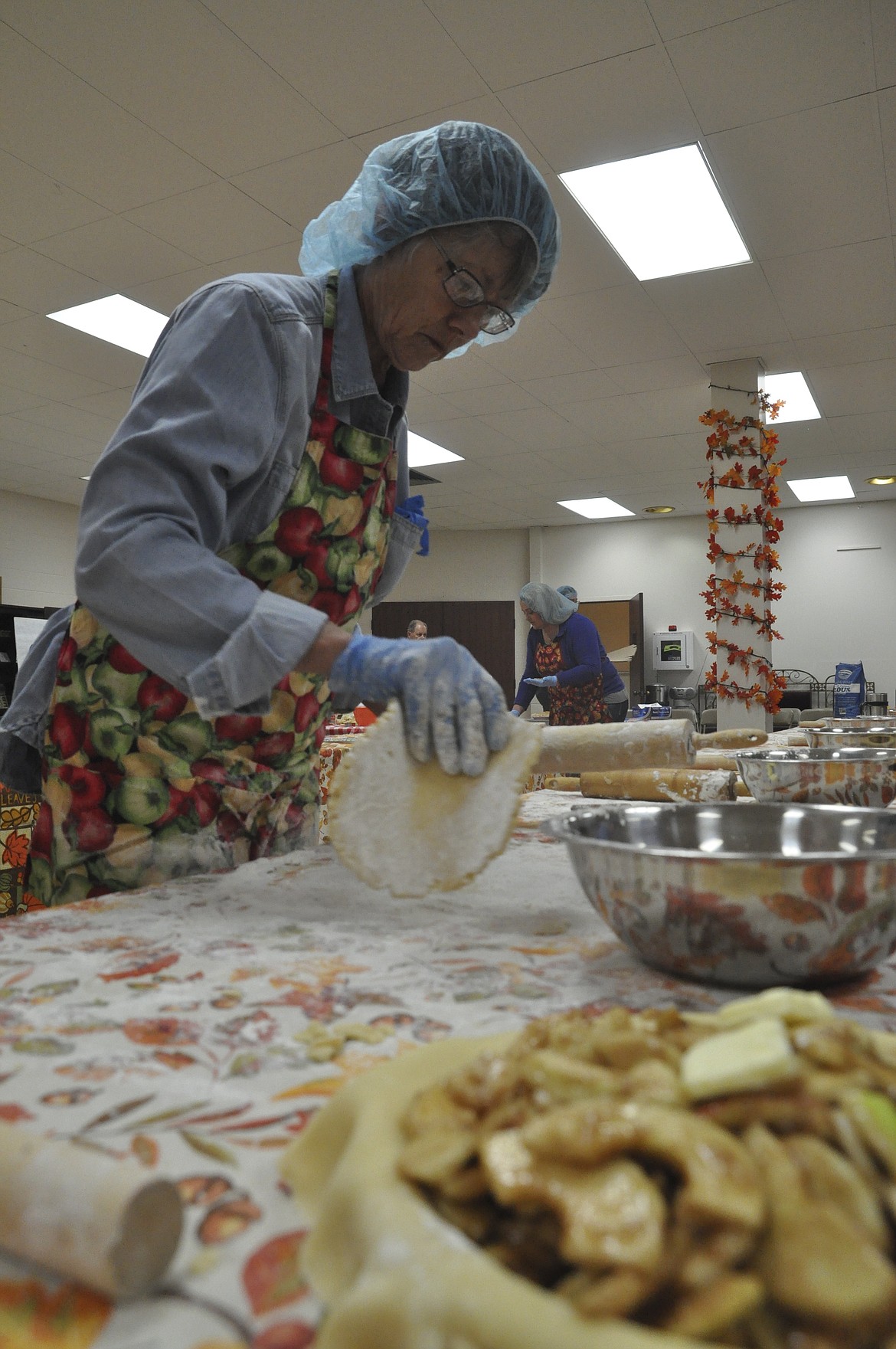 Ann Grende prepares to roll dough to add to an apple pie. (Ashley Fox/Lake County Leader)