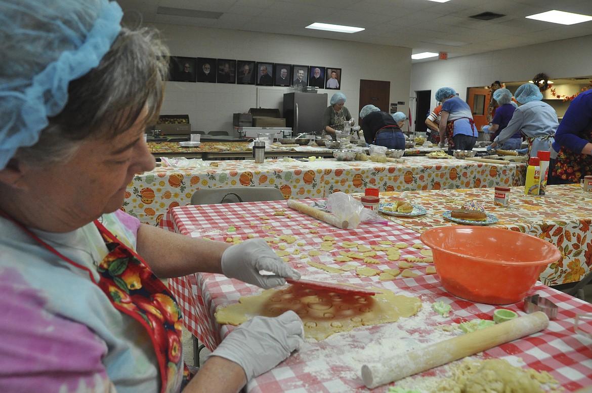 Georgie Huerta makes dough cutouts to be placed on top of apple pies once they are assembled. (Ashley Fox/Lake County Leader