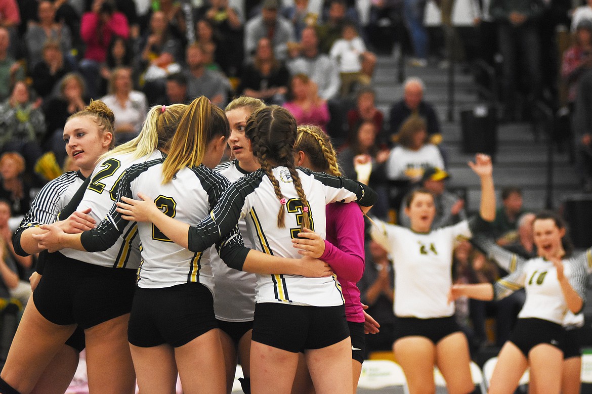 The Lady Dogs huddle up after a point against Stevensville on Thursday.