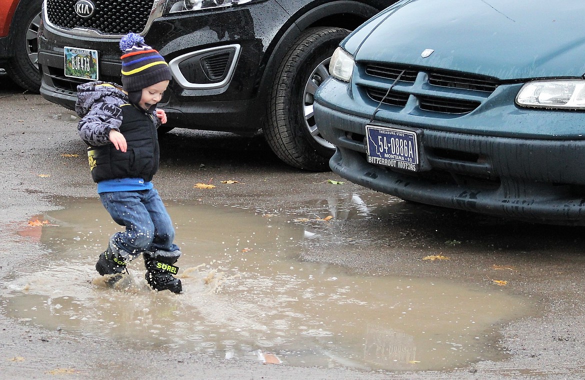 Not everyone hated the rain, 3-year-old Steven Mackey enjoyed splashing through the muddle puddles in the parking lot of Oktoberfest on Saturday.