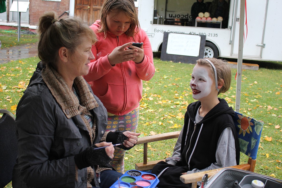 Terry Zylawy paints Wally Crosby&#146;s face into the clown from the popular thriller movie &#147;It&#148; on Saturday.