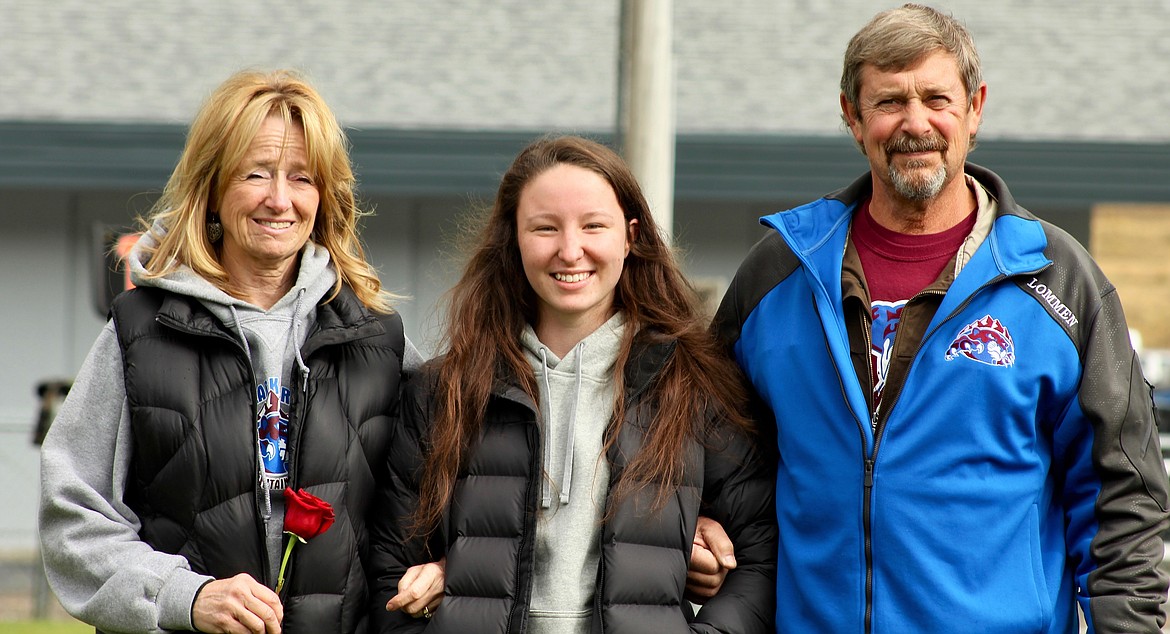 Team manager Hannah Calloway is escorted by her parents during the game on Oct. 7. (Photo by Frankie Kelly).