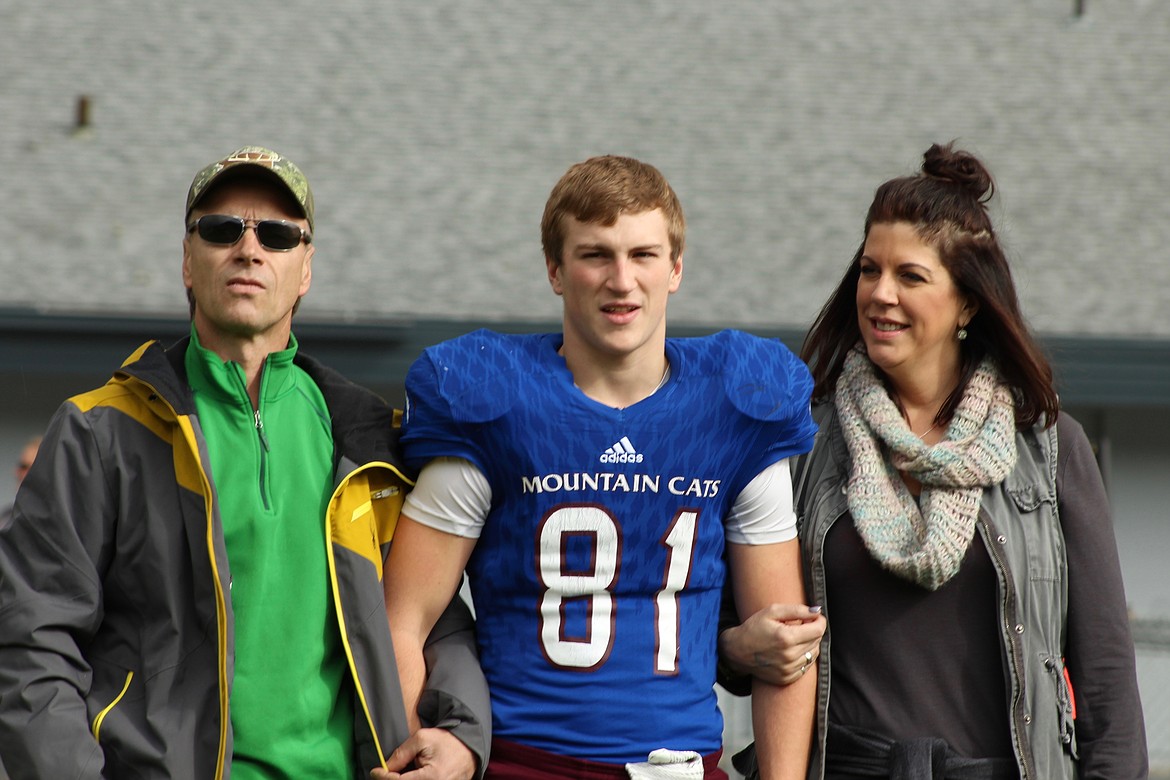 Connor Voll with his parents during Senior Day on Sat. Oct. 7 in Superior. (Photo by Frankie Kelly).