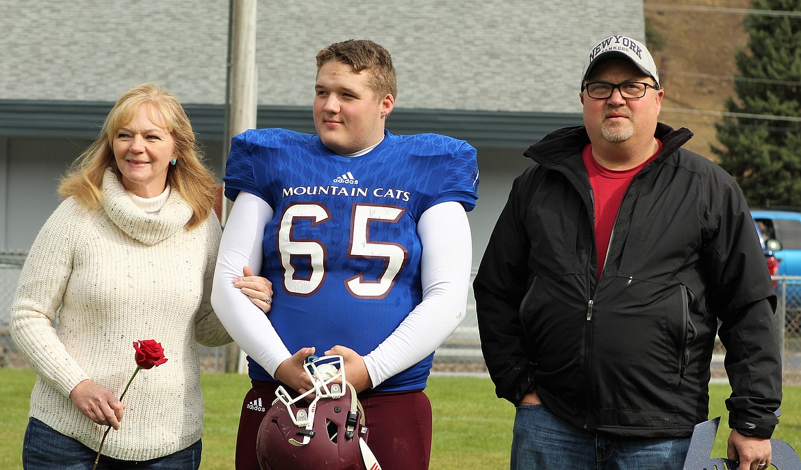 Evan Hall with his parents during Senior Day on Oct. 7 in Superior. (Photo by Frankie Kelly).