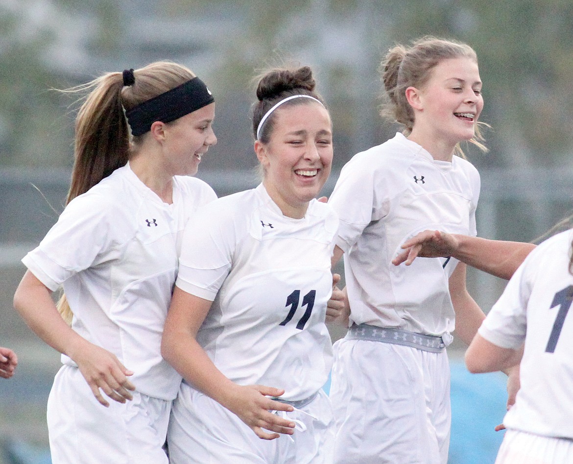 Junior Zoie Zpady, center, is all smiles after scoring in first half vs. Columbia Falls Friday. With Isabelle Martineau, left, and Elise Erickson. (Paul Sievers/The Western News)