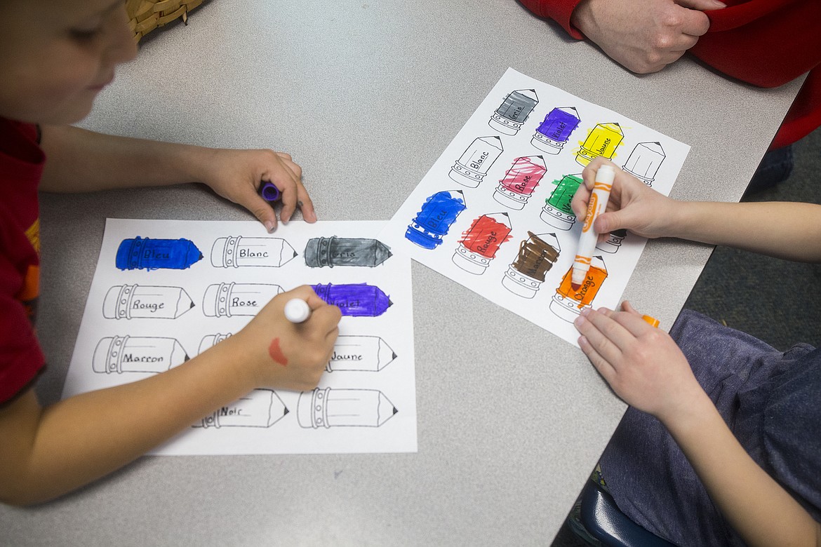 Skyway Elementary School students fill in crayons with the corresponding French color during class on Wednesday. A group of 20 Lake City High School French students worked in groups of three and four and introduced their younger counterparts to the color basics of the Romance language.