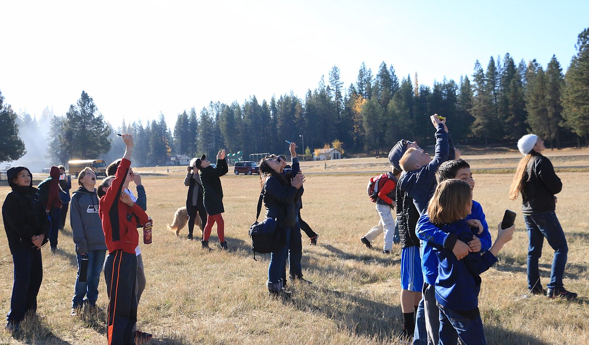 (Photo by MARY MALONE)
Students from Dinah Gaddie's Sandpoint Middle School class and Laura Spurway's Rathdrum gifted and talented class watch, with cameras and hugs, as a 1,200 gram weather balloon filled with helium and carrying a payload dissapears into the sky Friday as part of a Gizmo2Extremes project, a collaboration between Gizmo-CDA and the schools.