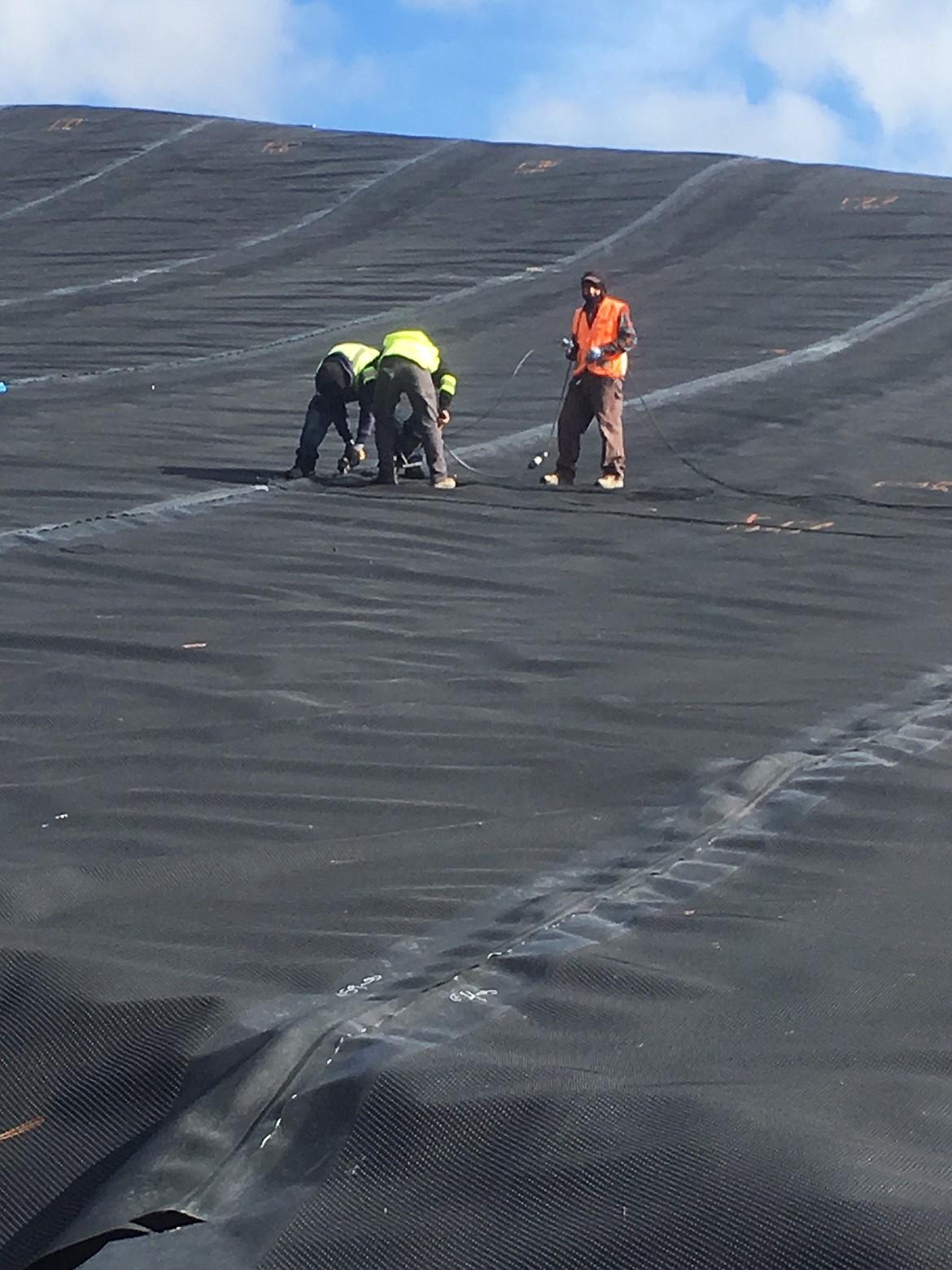 Courtesy photo
A crew buttons up a plastic lining at Kootenai County&#146;s landfill in Fighting Creek south of Coeur d&#146;Alene.