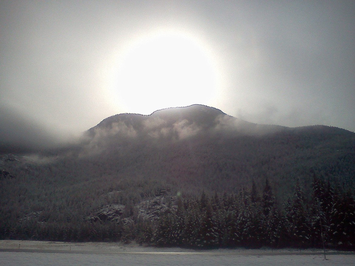 &#147;This photo was taken April 2013 at about 12:45 p.m. The sun was way to the right of Columbia Mountain. As soon as I took the photo the ball of light collapsed into a small orb and flew off toward the East and quickly disappeared. Two months later two of my employees witnessed the same thing. Other people have also reported seeing large balls of light on or over Columbia Mountain.&#148;
&#151; Joe Hauser