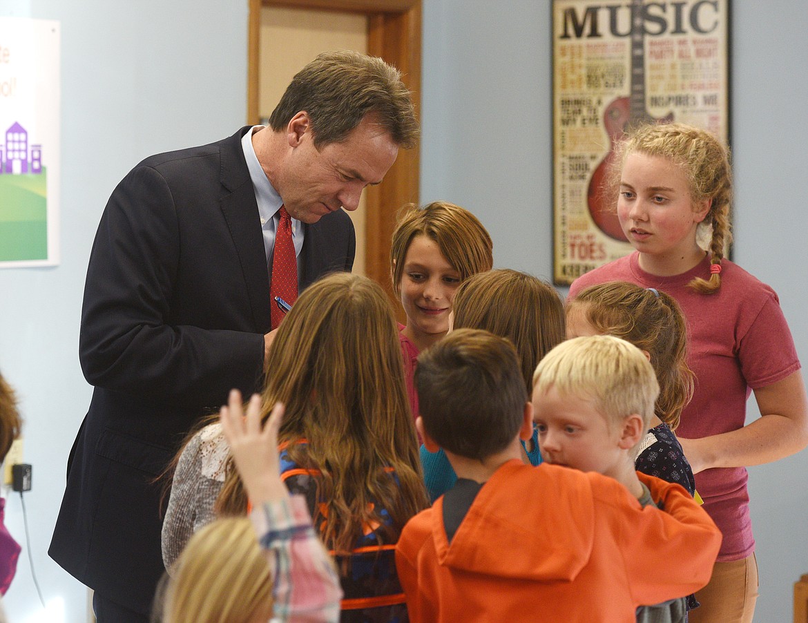 Montana Governor Steve Bullock signs authographs for Bigfork Arts Community Education Sports students after the Lights on Afterschool awareness campaign in Bigfork on Tuesday. (Aaric Bryan/Daily Inter Lake)