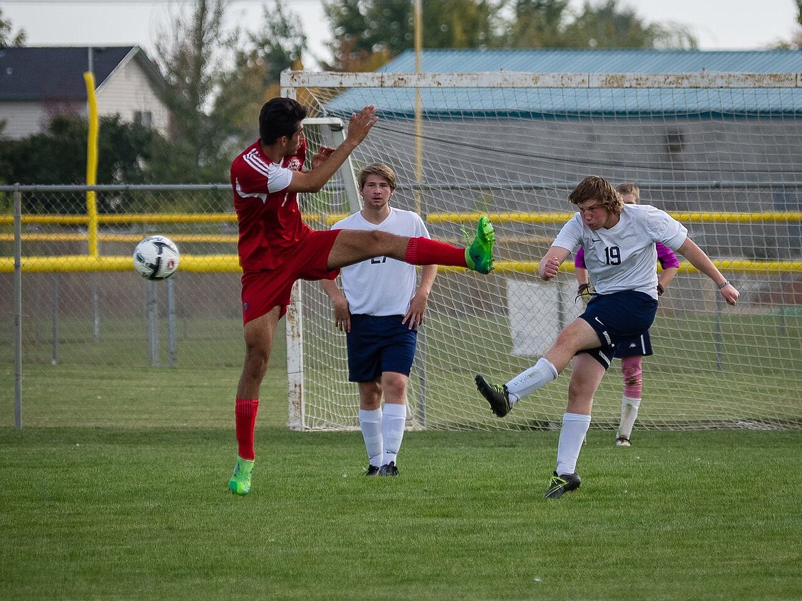 Photo by Doug Beazer
Drew Foster clearing the ball from Bonners Ferry end of the field. Gabe See in back ground.