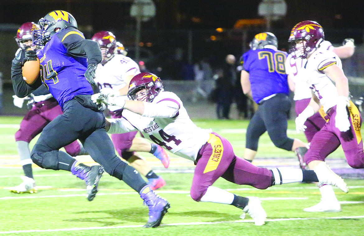 Connor Vanderweyst/Columbia Basin Herald
Moses Lake linebacker David Hersch (44) pulls down Wenatchee's Nathan Blauman Friday at the Apple Bowl.