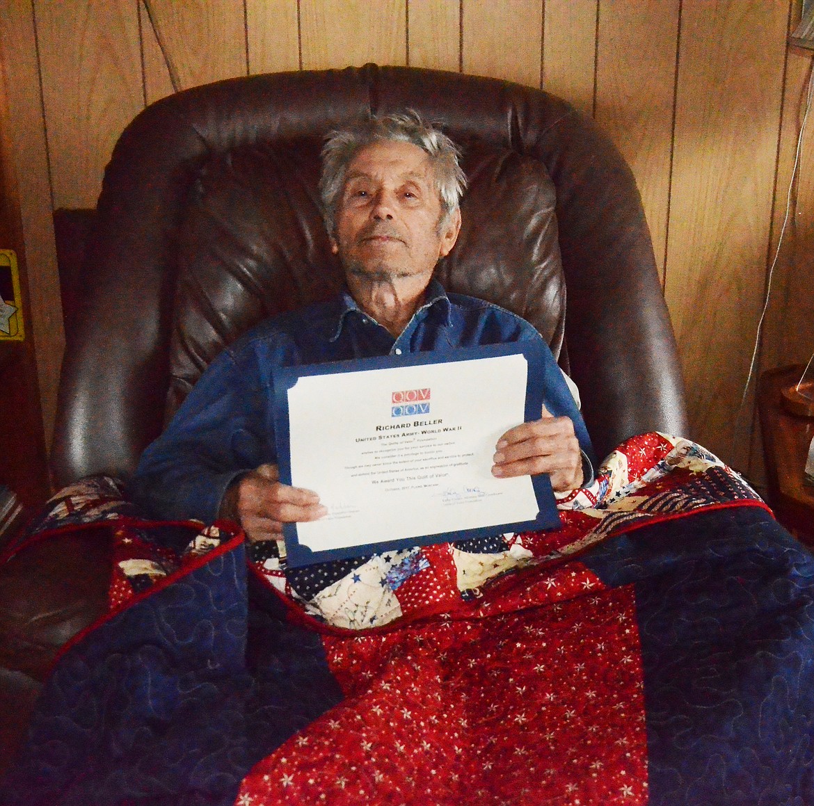 Richard Beller with his certificate and handmade quilt that was presented to him last week. (Erin  Jusseaume/ Clark Fork Valley Press)