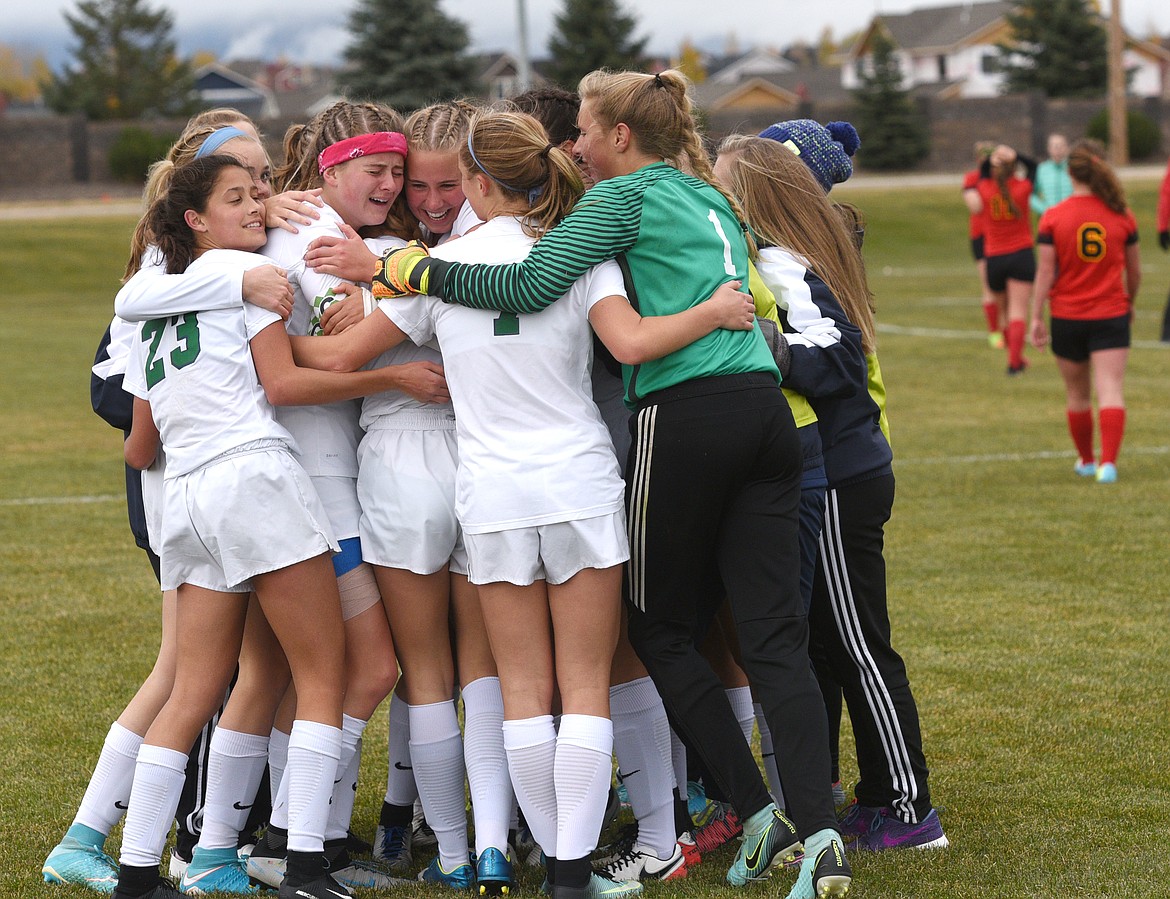 The Glacier Wolfpack celebrate their 3-1 victory over Hellgate at Glacier to earn a trip to the state tournament. (Aaric Bryan/Daily Inter Lake)