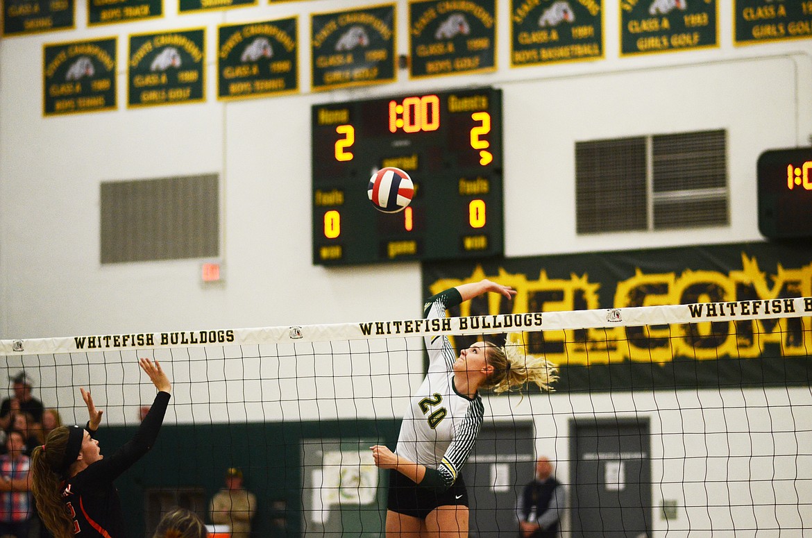 Senior Cailyn Ross rises for the kill against Ronan last Tuesday. (Daniel McKay/Whitefish Pilot)