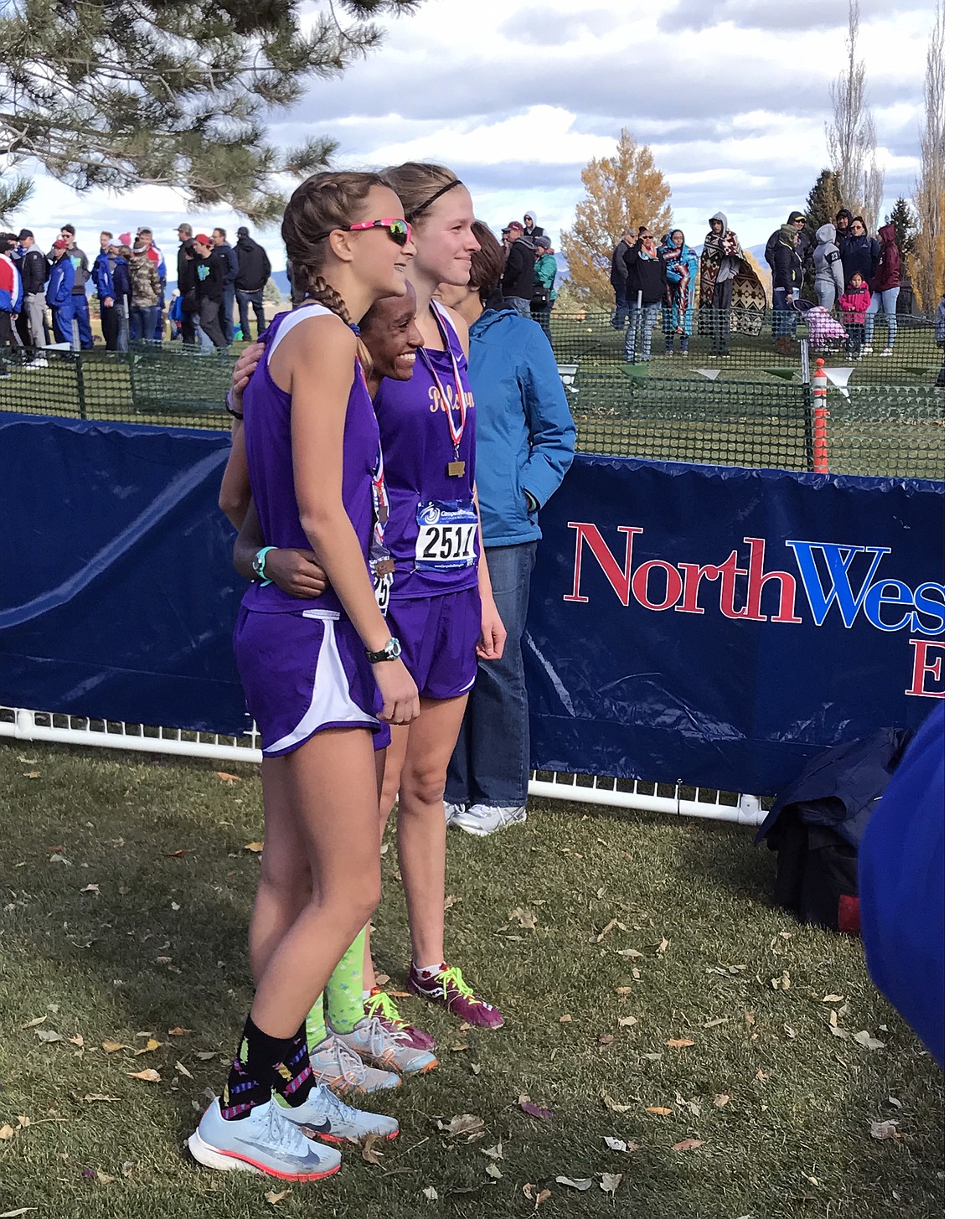 POLSON CROSS country runner Bea Frissell (far right) poses with Naima Crowl (middle) and Molly Sitter (far left) at the conclusion of the Montana High School Athletic Association Cross Country race Saturday at Helena. (Photo courtesy of Lindsay Rossmiller, 406 MT Sports)