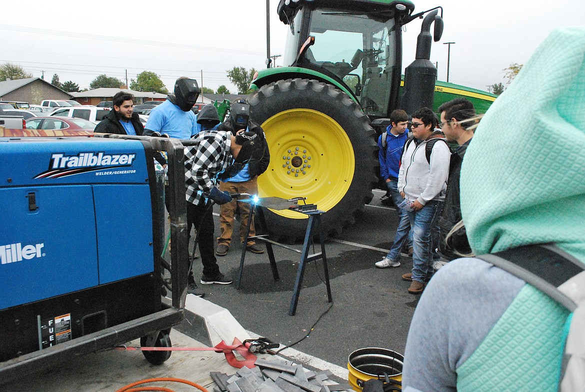 Bob Kirkpatrick/The Sun Tribune - An OHS student learns how to spark an arch from a welding instructor at Columbia Basin Technical Skills Center.