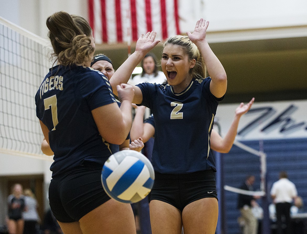 McKeeley Tonkin (2) of Timberlake High School celebrates a point with teammate Kenzie Dean during a match vs. Kimberly in the opening round of the state 3A volleyball tournament last Friday at Lake City High School. 
LOREN BENOIT/Press