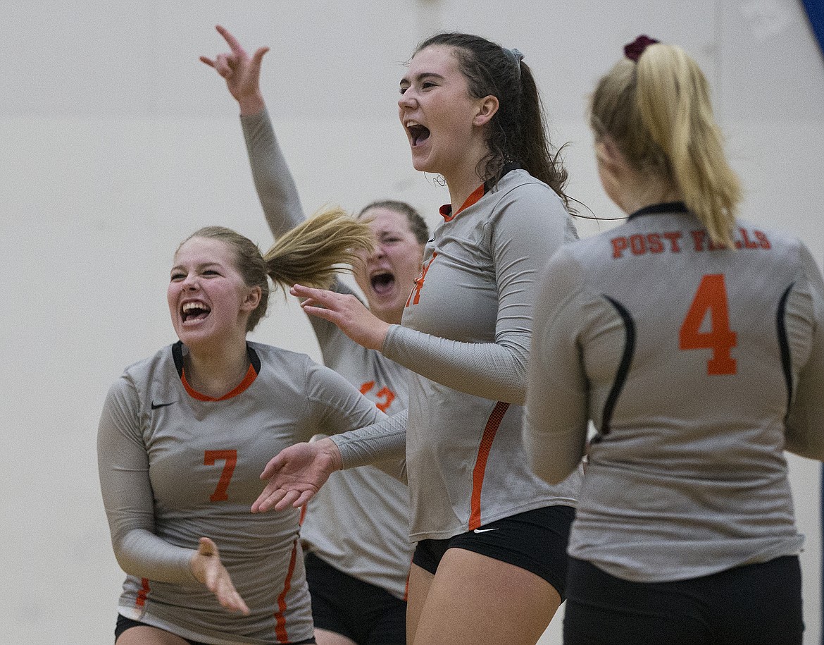 LOREN BENOIT/Press
Sydney Parks (14) of Post Falls celebrates a key point against Eagle High with her teammates in the opening round of the state 5A volleyball tournament on Friday.