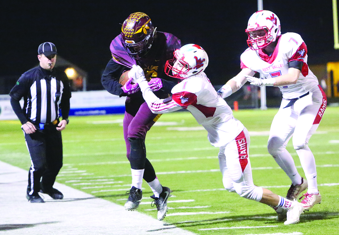 Connor Vanderweyst/Columbia Basin Herald
Moses Lake receiver Kyler Haneberg is driven out of bounds by West Valley defenders.