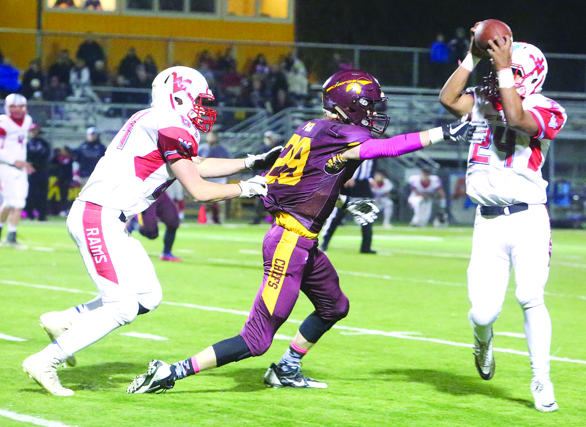 Connor Vanderweyst/Columbia Basin Herald
Moses Lake cornerback Blake Pugh (middle) is held while trying to defend a pass.