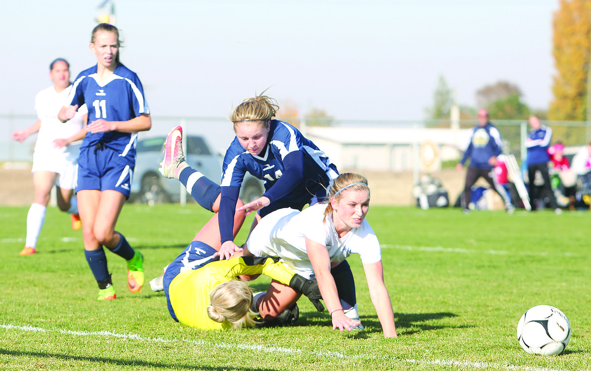 Connor Vanderweyst/Columbia Basin Herald
Warden forward Aubree Skone collides with Naches Valley goalie Torrie Hoover.