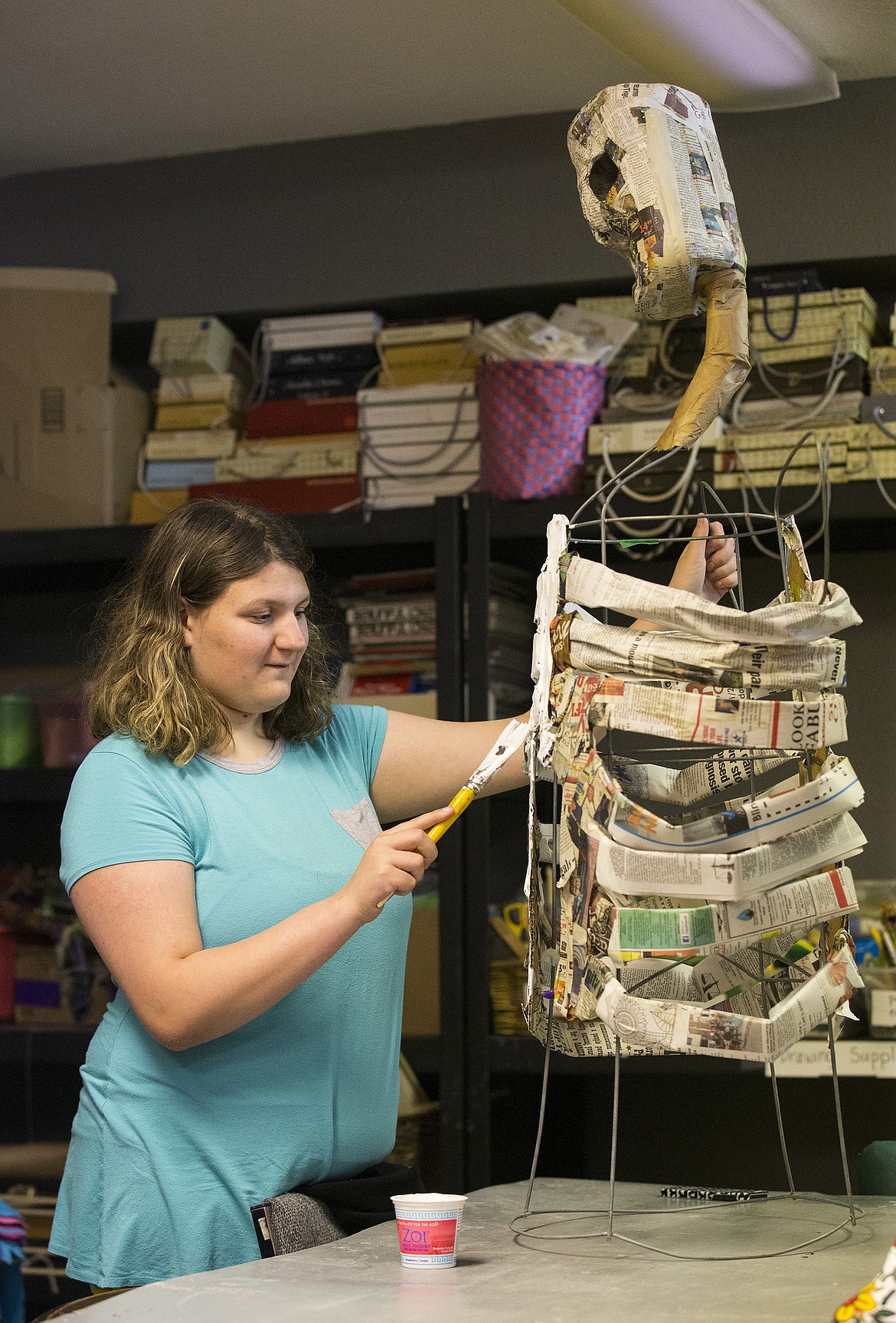 LOREN BENOIT/PressHeaven Schumacher paints the ribs of her newspaper skeleton during an art workshop at Emerge last Thursday. Students who attended the three workshops will display their artwork at the Day of the Dead Fiesta on Thursday at the Human Rights Education Institute.