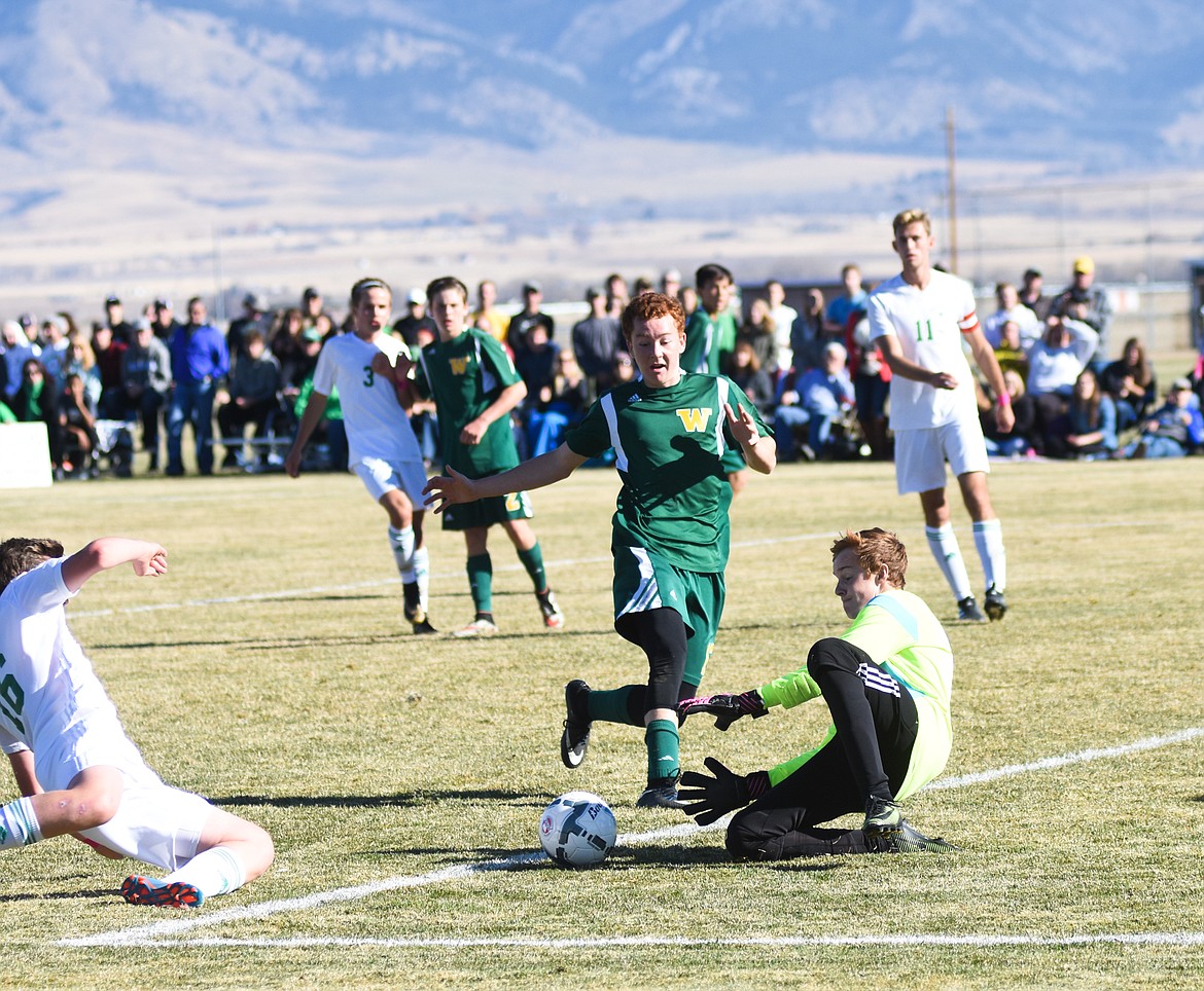 Goalie Bradlee Anderson slides in to block a Belgrade shot.