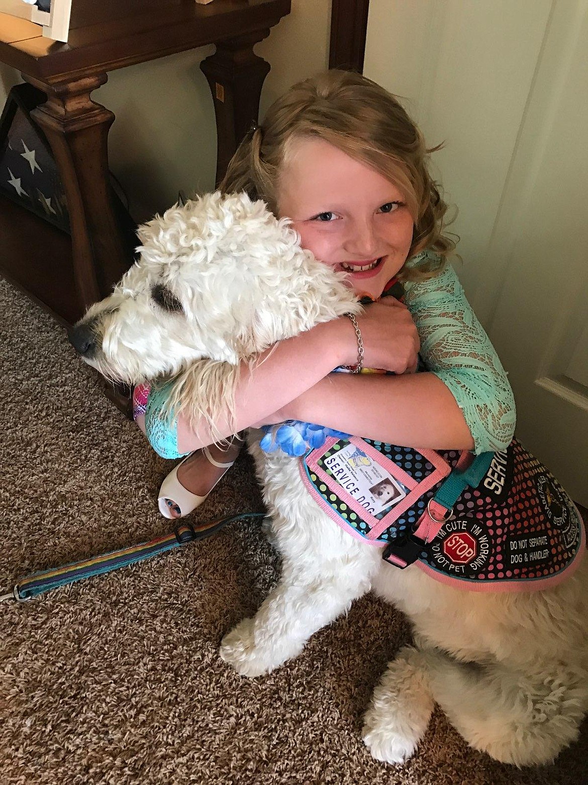 Hailie &quot;Halo&quot; Neufeld, 11, cuddles with Rory, her diabetes detection dog that she got to help monitor her health. Hailie and a nonprofit formed by her mom and others, Halo's One Hope, is hosting the &#147;Light up the Town Blue&#148; event on The Coeur d'Alene Resort lawn at 5 p.m. Monday to raise awareness for diabetes during Diabetes Awareness month, commence Diabetes Awareness Week in Coeur d'Alene and raise funds for three families with children who have recently been diagnosed. (Courtesy photo)