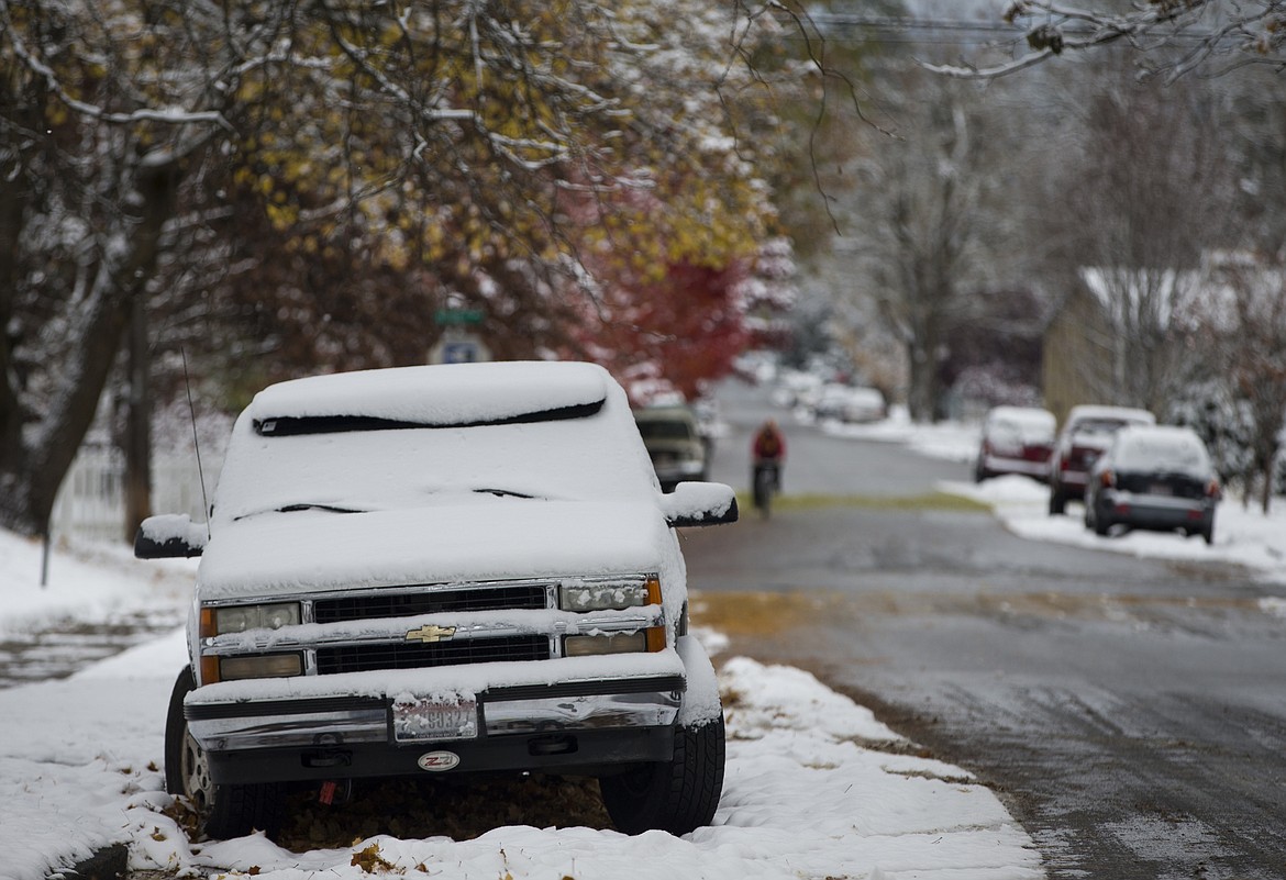 LOREN BENOIT/Press
Fresh snow rests atop a parked truck on Lakeside Avenue Monday morning in downtown Coeur d&#146;Alene. The city is making an effort to ensure motorists can safely navigate streets this winter by getting cars, campers and boats off the streets.