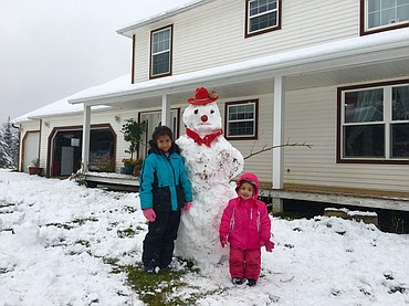 ITS BEGINNING TO LOOK A LOT LIKE WINTER: Pinky H. of St. Maries shared this photo of her kids, Nisha and Bayleigh, showing off their icy new friend.