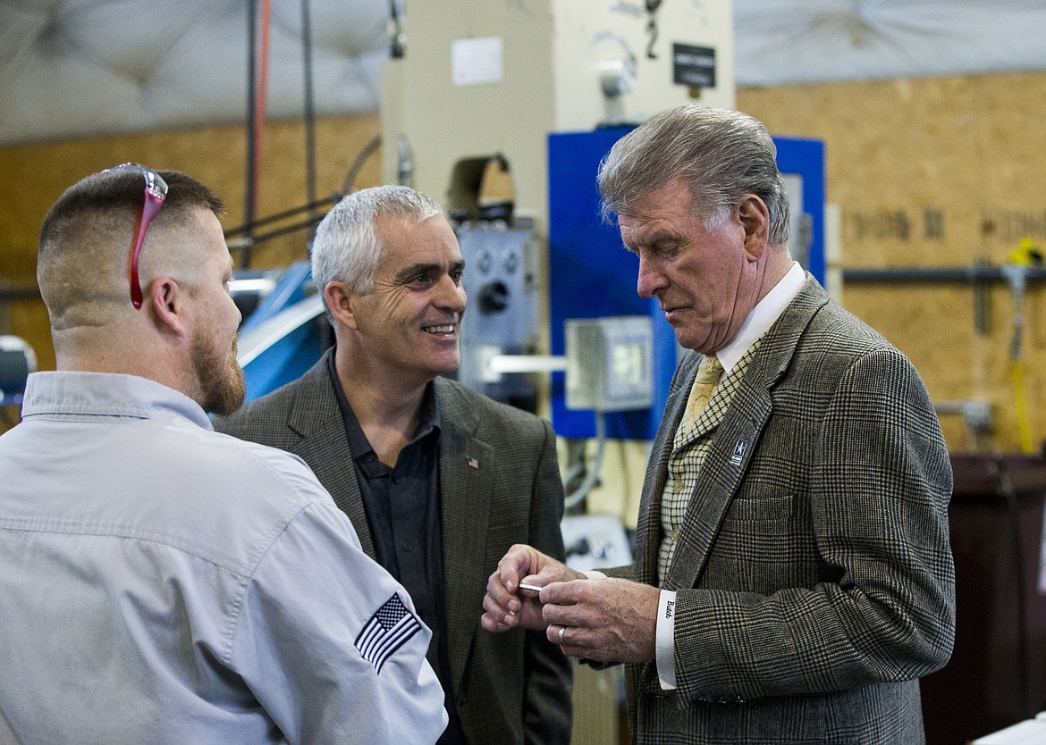 Idaho Gov. Butch Otter, right, inspects a switchblade component Wednesday afternoon at Swiss Tech Precision in Post Falls with Swiss Tech president Chris Choate, center, and vice president Scot Frazer. Otter spoke to  Coeur d'Alene Chamber of Commerce members about high tech businesses and the Idaho economy before visiting Swiss Tech.  (LOREN BENOIT/Press)