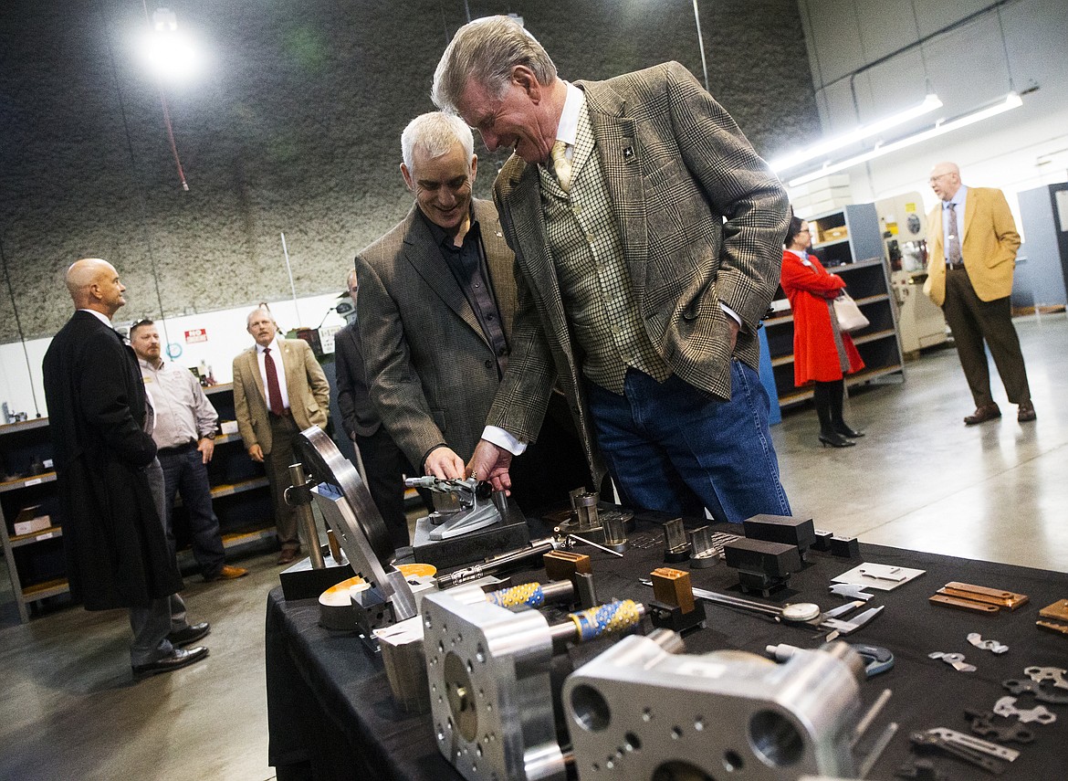 Swiss Tech Precision president Chris Choate and Idaho Gov. Butch Otter look at a digital micrometer during Otter's tour of the business Wednesday afternoon in Post Falls. (LOREN BENOIT/Press)