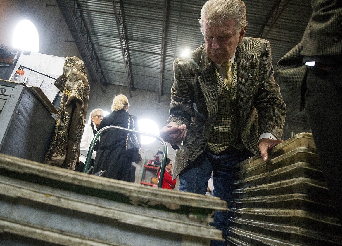 Idaho Gov. Butch Otter picks up a switchblade component during his tour of Swiss Tech Precision Wednesday afternoon in Post Falls. (LOREN BENOIT/Press)