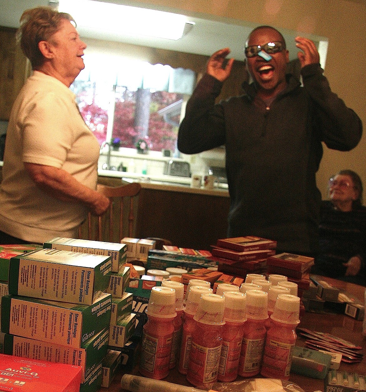 BRIAN WALKER/Press
Brave Sikangila, a medical coordinator from Zambia, reacts to the donations he received from Coeur d'Alene's Kathy Pierce, including sunglasses, Band-Aids, toothpaste and other supplies on Thursday.