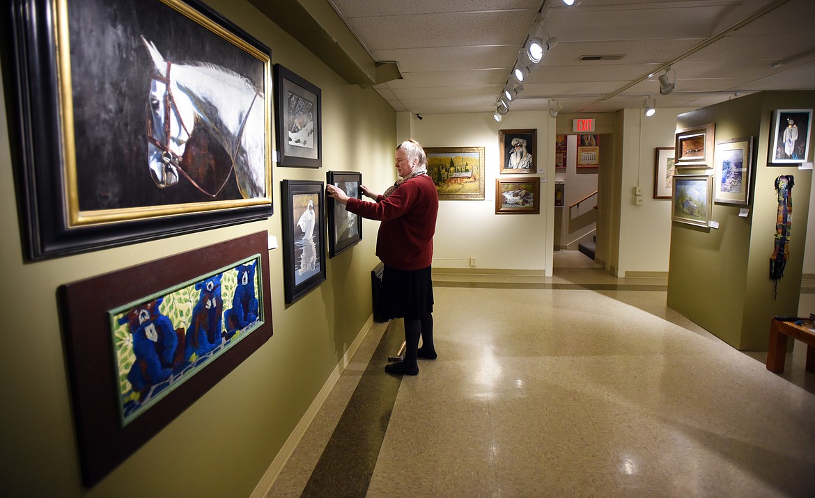 Celinda English hangs paintings as she prepares for the 2017 Members&#146; Salon, which opens with a reception from 5 to 7 p.m. Thursday, Nov. 9. (Brenda Ahearn photos/This Week in the Flathead)