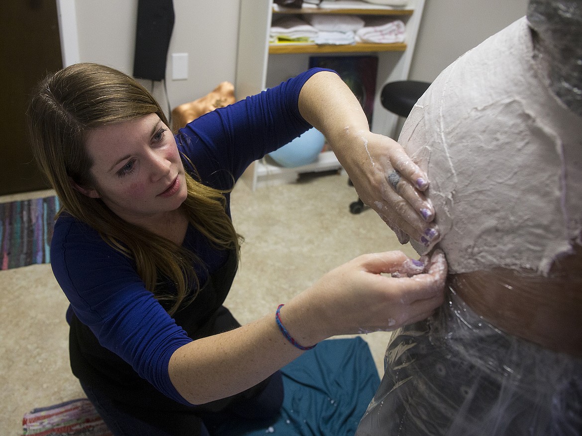 LOREN BENOIT/PressRayne Andrews, the artist who creates the casts at Ancient Paths Birth and Wellness in Coeur d'Alene, has been plastering mamas' bellies since the center opened in 2015.