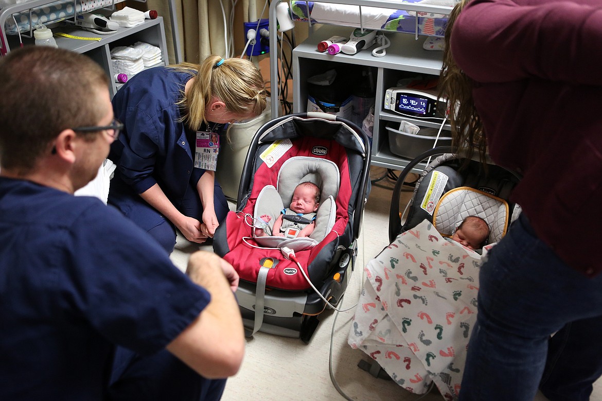 Fraternal twin brothers, Judah and Jedidiah Hall, undergo a carseat test at the Kalispell Regional Medical Center NICU to make sure the babies can regulate their body temperatures on the ride home from the hospital. Nursing student Jonathan Madany and NICU nurse Sarah Zaharia check on the boys, alonside their mother, Cassandra Hall. (Mackenzie Reiss/Daily Inter Lake)