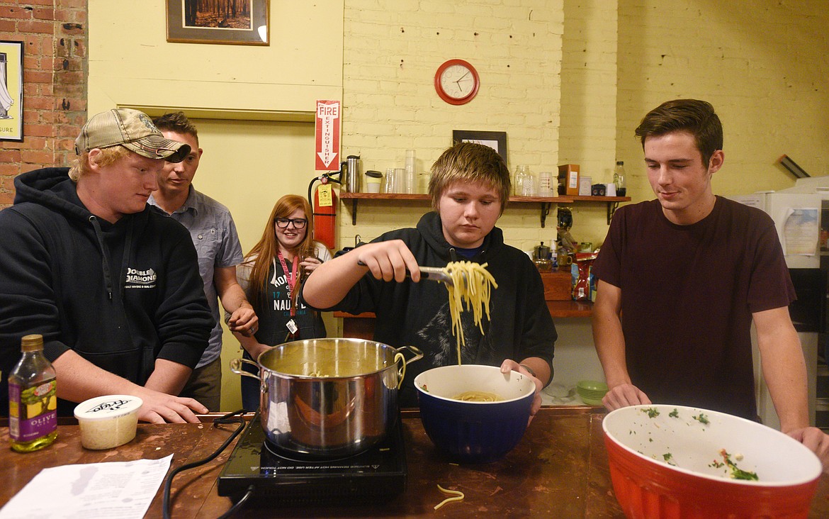 Participants of the Center for Restorative Youth Justice in Kalispell make dinner recently.