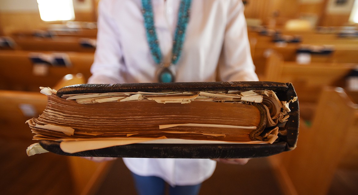 Mary Todd holds one of the oversized pulpit Bibles.