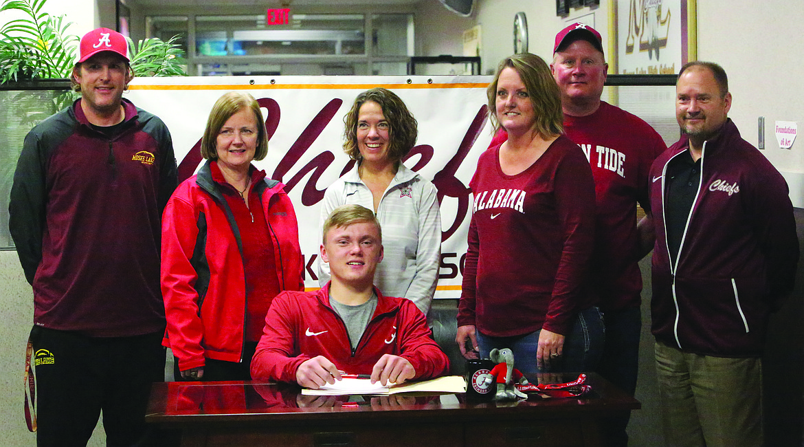 Connor Vanderweyst/Columbia Basin Herald
Spencer Kimbro (seated) poses with (left to right) Kevin Whittall, Tomie Zuchetto, Teresa Skinner, Robin Kimbro, Dan Kimbro and Loren Sandhop after signing his national letter of intent to the University of Alabama.