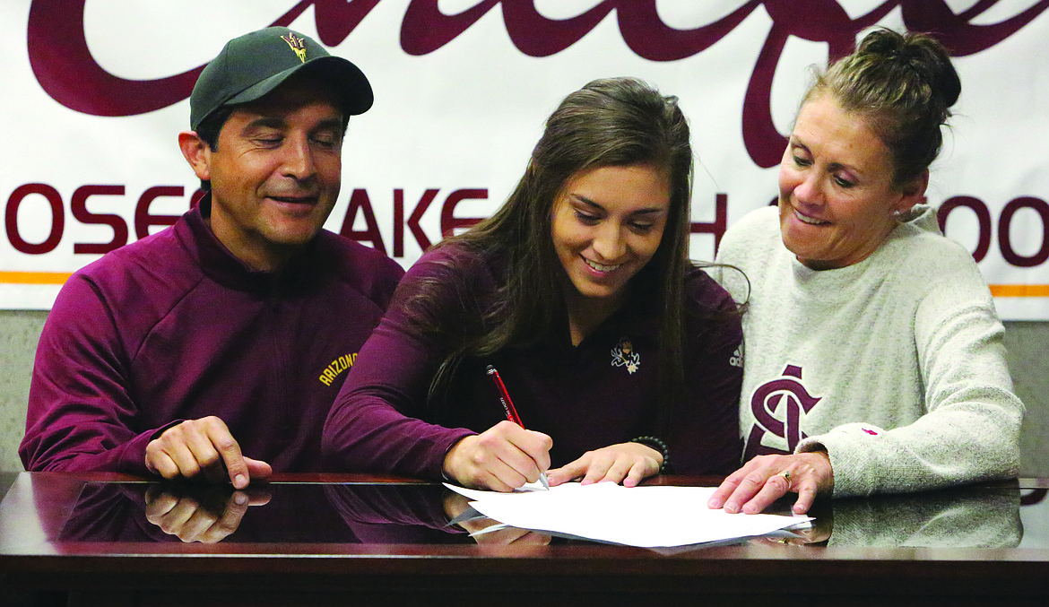 Connor Vanderweyst/Columbia Basin Herald
Moses Lake basketball player Jamie Loera signs her national letter of intent to Arizona State University with parents Javier and Lori Loera.