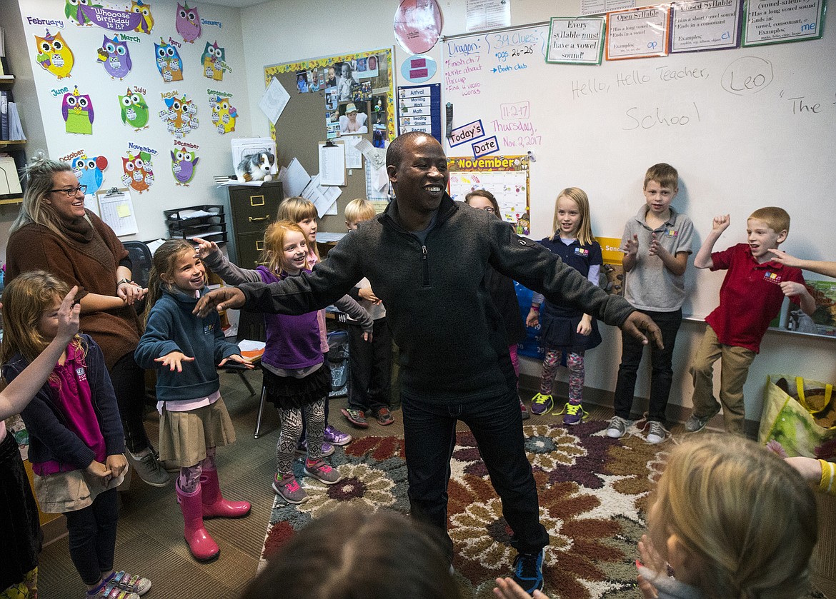 LOREN BENOIT/Press
Brave Sikangila, a medical coordinator from Zambia, leads a group of second-graders through a dance Thursday afternoon at Sorensen Magnet School of Arts and Humanities.