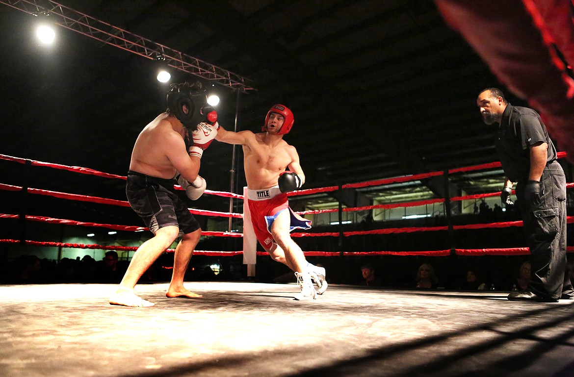 Taylor Reed, of Kalispell, lands a punch on opponent Marhsall Sutherland during their amateur boxing match Oct. 28. (Mackenzie Reiss/Daily Inter Lake)