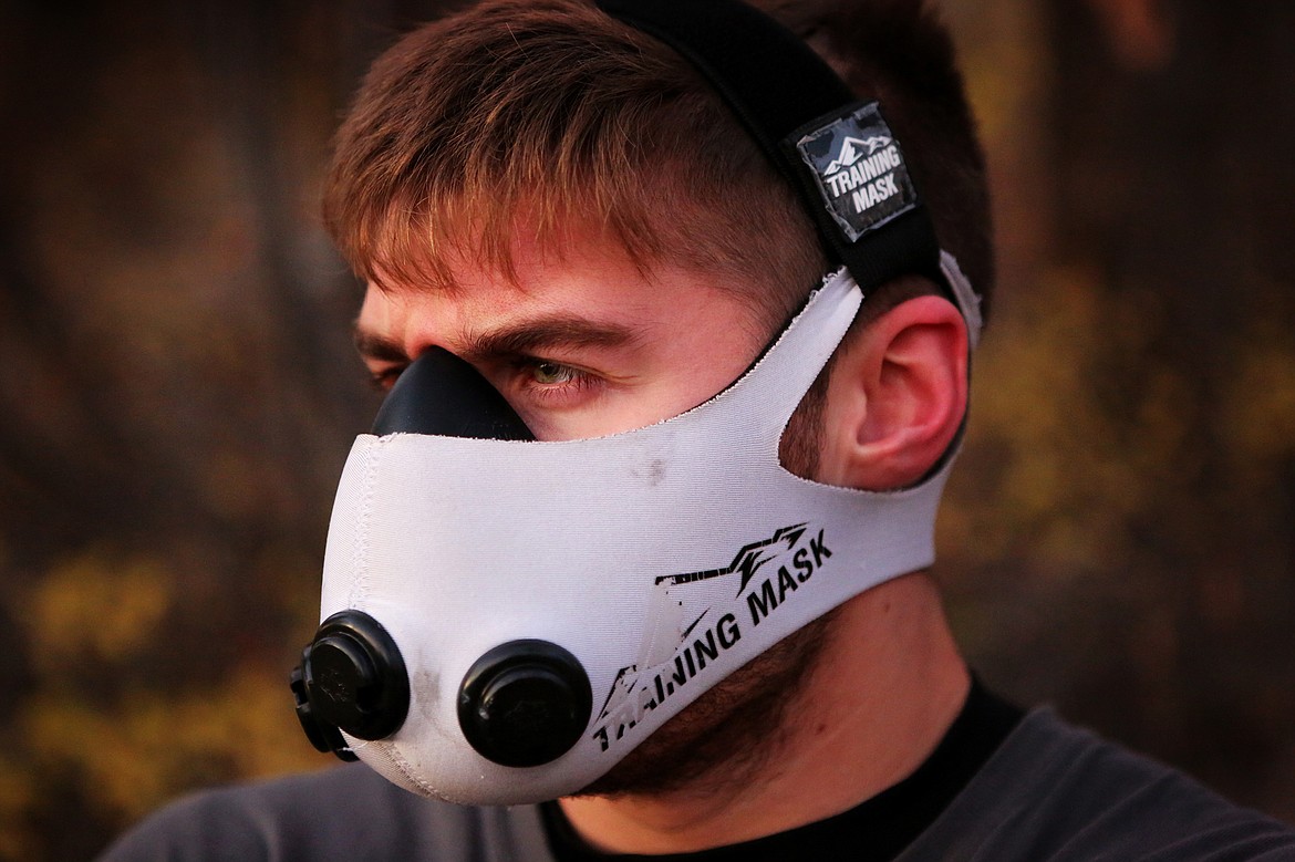 Taylor Reed, 20, uses an altitude mask when running to simulate the effects of running at elevation at Lone Pine State Park. (Mackenzie Reiss/Daily Inter Lake)