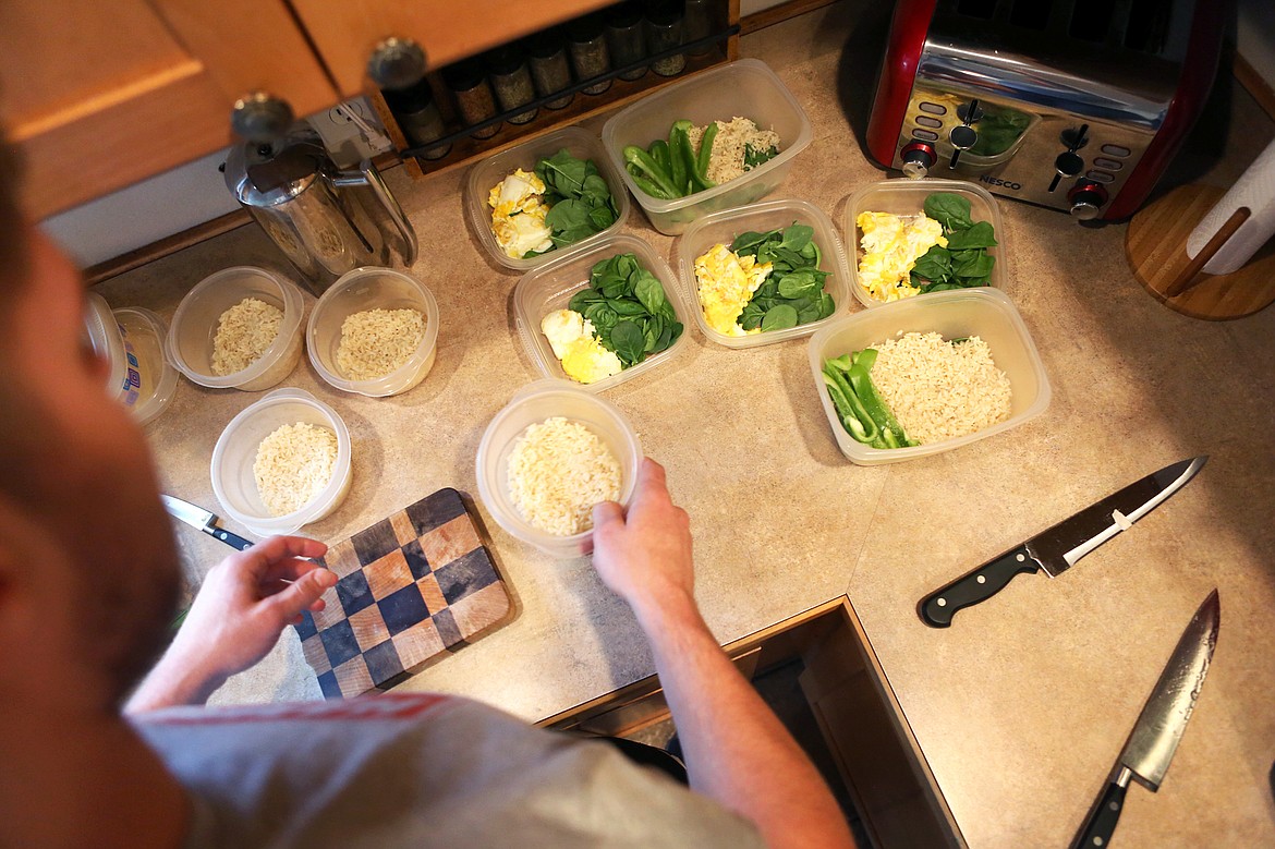 Reed prepares meals for the week at his Kalispell residence. Reed eats between 4,500 and 5,000 calories per day when he&#146;s training for a fight.