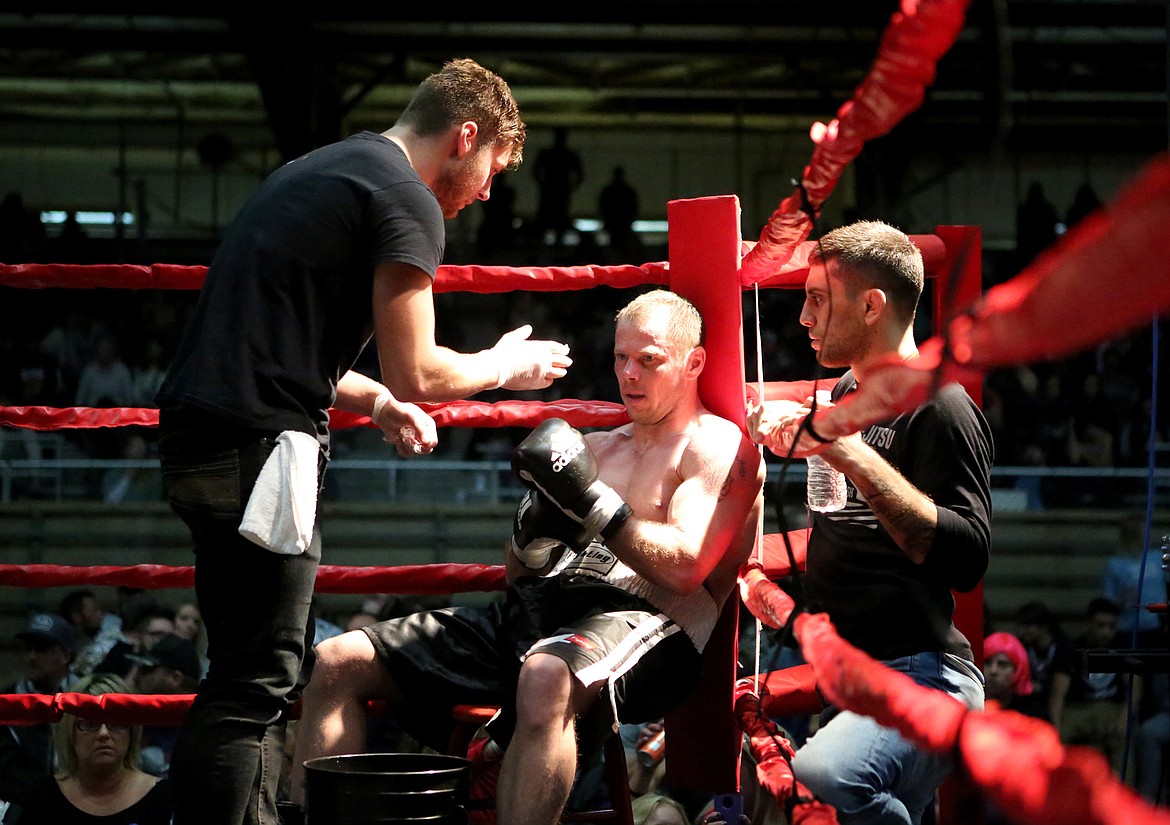 Taylor Reed, left, applies Vaseline to Jesse Uhde&#146;s face between rounds during Fight Night 6 at the Majestic Valley Arena in Kalispell. The Oct. 28 fight was Reed&#146;s first time cornering his coach. (Mackenzie Reiss/Daily Inter Lake)